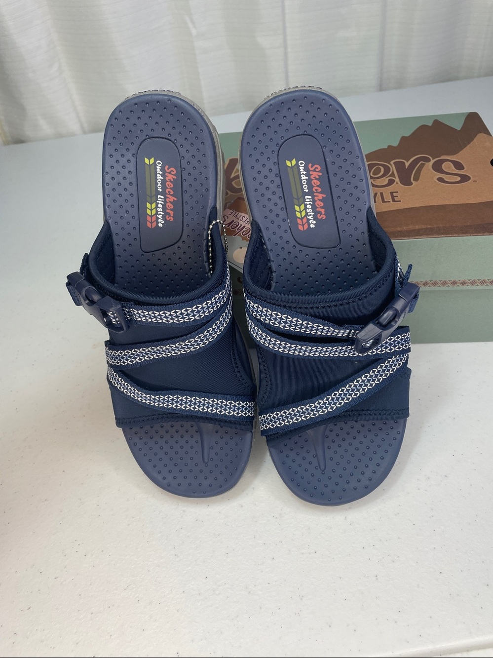 Skechers women’s Navy and White Slip-On Sport Sandals